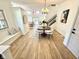 Open-concept dining area with modern furniture, hardwood floors, and large windows at 653 Southridge Ct, Westfield, IN 46074