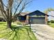 Charming home with a gray two-car garage, brick accents, and a well-manicured lawn at 653 Southridge Ct, Westfield, IN 46074
