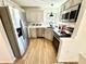 Well-lit kitchen with stainless steel appliances, white countertops, and wood flooring at 653 Southridge Ct, Westfield, IN 46074