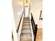 Carpeted stairway with black handrail and white trim leading to the upper level at 653 Southridge Ct, Westfield, IN 46074