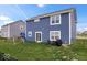 The backyard features a full fence, a play set, a grill, and a sliding door at 6536 W Shoreline Ct, Greenfield, IN 46140