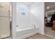 Bright bathroom featuring a soaking tub with a view, a shower, and access to a closet at 6536 W Shoreline Ct, Greenfield, IN 46140