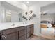 Bathroom features a double sink vanity with a large mirror and a doorway view of the main bedroom at 6536 W Shoreline Ct, Greenfield, IN 46140