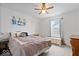 Comfortable bedroom with a large window view, ceiling fan, and wood nightstand at 6536 W Shoreline Ct, Greenfield, IN 46140