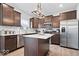 Modern kitchen with stainless steel appliances, granite countertops, and dark cabinets provides a sleek and functional cooking space at 6536 W Shoreline Ct, Greenfield, IN 46140