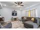 Inviting living room with plush seating, a ceiling fan, and a wall-mounted television provides a relaxing atmosphere at 6536 W Shoreline Ct, Greenfield, IN 46140