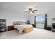 Spacious main bedroom with a ceiling fan, window view, and wooden chest at the foot of the bed at 6536 W Shoreline Ct, Greenfield, IN 46140