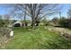 Expansive backyard featuring lush green grass and mature trees, perfect for outdoor activities and relaxation at 6622 Stanley Rd, Camby, IN 46113