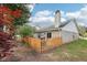 The backyard features a privacy fence, brick exterior, and mature trees, offering a serene outdoor area at 6853 Arjay Dr, Indianapolis, IN 46217