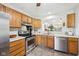 Bright kitchen with stainless steel appliances and a pass-through to the dining area at 6853 Arjay Dr, Indianapolis, IN 46217