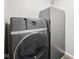 This well-equipped laundry room features a front-load washer and an upright freezer at 6853 Arjay Dr, Indianapolis, IN 46217