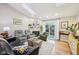 Bright living room with a vaulted ceiling, skylight, fireplace, and hardwood floors at 6853 Arjay Dr, Indianapolis, IN 46217