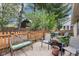 Cozy backyard patio area surrounded by a wooden fence, mature trees and assorted outdoor furniture at 6853 Arjay Dr, Indianapolis, IN 46217