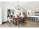 Modern dining area showcasing a wooden table, stylish chairs, bench seating, and an open view into the kitchen at 7007 Myra Way, Indianapolis, IN 46239