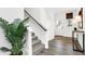 Bright entryway with hardwood floors, staircase, and a decorative plant, welcoming you home at 7007 Myra Way, Indianapolis, IN 46239