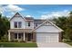 Charming two-story home featuring a brick and siding facade, inviting front porch, and attached two-car garage at 7125 Maidstone Cv, McCordsville, IN 46055