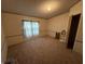 Empty bedroom featuring carpet flooring, neutral paint, wood trim, and a window at 7765 N 225 W, Lebanon, IN 46052