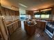 Spacious kitchen featuring wood cabinets, laminate countertops and flooring, and a kitchen island at 7765 N 225 W, Lebanon, IN 46052
