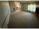 Large living room featuring carpet flooring, neutral paint, wood trim, and a window at 7765 N 225 W, Lebanon, IN 46052