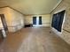 Empty living room featuring carpet flooring, neutral paint, wood trim, and a window at 7765 N 225 W, Lebanon, IN 46052