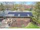 Aerial view of brick home with solar panels, concrete patio, and spacious backyard at 8051 Sycamore Springs Trl, Indianapolis, IN 46239