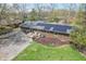 Brick home featuring a large backyard patio area, solar panels and a well maintained lawn at 8051 Sycamore Springs Trl, Indianapolis, IN 46239