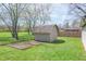 Backyard with a storage shed, garden beds and grassy lawn at 8051 Sycamore Springs Trl, Indianapolis, IN 46239