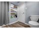 Cozy bathroom with a toilet and built-in storage shelving and white walls at 8051 Sycamore Springs Trl, Indianapolis, IN 46239