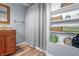 Bathroom with vanity, open storage shelves with linens, and light blue wall at 8051 Sycamore Springs Trl, Indianapolis, IN 46239