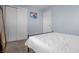 Bright bedroom featuring light blue walls, white trim, and closet space at 8051 Sycamore Springs Trl, Indianapolis, IN 46239