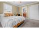 Bright bedroom with a comfortable bed, ceiling fan, and inviting ambiance perfect for rest and relaxation at 8051 Sycamore Springs Trl, Indianapolis, IN 46239