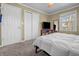 Comfortable bedroom featuring neutral tones, natural light, and convenient closet space at 8051 Sycamore Springs Trl, Indianapolis, IN 46239