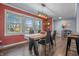 A dining room with a wooden table, a large window, and an open view to the kitchen at 8051 Sycamore Springs Trl, Indianapolis, IN 46239
