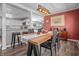 A brightly lit dining room with a large wooden table and a view into the living room at 8051 Sycamore Springs Trl, Indianapolis, IN 46239