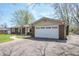 A brick house showing the two-car garage with lots of driveway space at 8051 Sycamore Springs Trl, Indianapolis, IN 46239