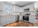 Updated kitchen features stainless steel appliances, white cabinetry, granite countertops and subway tile backsplash at 8051 Sycamore Springs Trl, Indianapolis, IN 46239