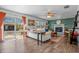 Bright living room with hardwood floors, stylish furniture, ceiling fan, fireplace, and access to backyard at 8051 Sycamore Springs Trl, Indianapolis, IN 46239