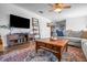 Open-concept living area showcasing a comfortable sofa and a vintage wooden coffee table on an ornamental rug at 8051 Sycamore Springs Trl, Indianapolis, IN 46239