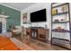 A modern living room featuring a stacked stone fireplace, sleek media center and hardwood flooring at 8051 Sycamore Springs Trl, Indianapolis, IN 46239