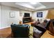 Finished basement with comfortable seating, TV, fireplace, and wood-look floors is ideal for relaxation and entertainment at 8069 Middle Bay Ln, Indianapolis, IN 46236