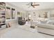 Spacious basement with a comfortable seating arrangement, built-in shelving, and natural light from a window at 8069 Middle Bay Ln, Indianapolis, IN 46236