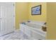 White bathroom featuring a soaking tub and tile flooring at 8069 Middle Bay Ln, Indianapolis, IN 46236