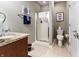 Modern bathroom with tiled floors, walk-in shower, updated vanity and neutral colors at 8069 Middle Bay Ln, Indianapolis, IN 46236