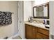 Well-lit bathroom with a granite countertop, wooden vanity, and a framed mirror at 8069 Middle Bay Ln, Indianapolis, IN 46236