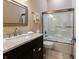 Well-lit bathroom features a modern vanity, a framed mirror, and a shower with a sliding glass door at 8069 Middle Bay Ln, Indianapolis, IN 46236