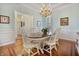 Bright dining room with hardwood floors, wainscoting, and a decorative chandelier at 8069 Middle Bay Ln, Indianapolis, IN 46236