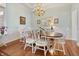 Elegant dining room features a wood table, chandelier and lots of natural light at 8069 Middle Bay Ln, Indianapolis, IN 46236