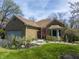 Charming stone home featuring an attached garage and beautifully landscaped front yard at 8069 Middle Bay Ln, Indianapolis, IN 46236