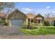 Charming stone home featuring an attached garage and beautifully landscaped front yard at 8069 Middle Bay Ln, Indianapolis, IN 46236