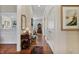 Inviting hallway with hardwood floors, white trim, and view to other rooms at 8069 Middle Bay Ln, Indianapolis, IN 46236